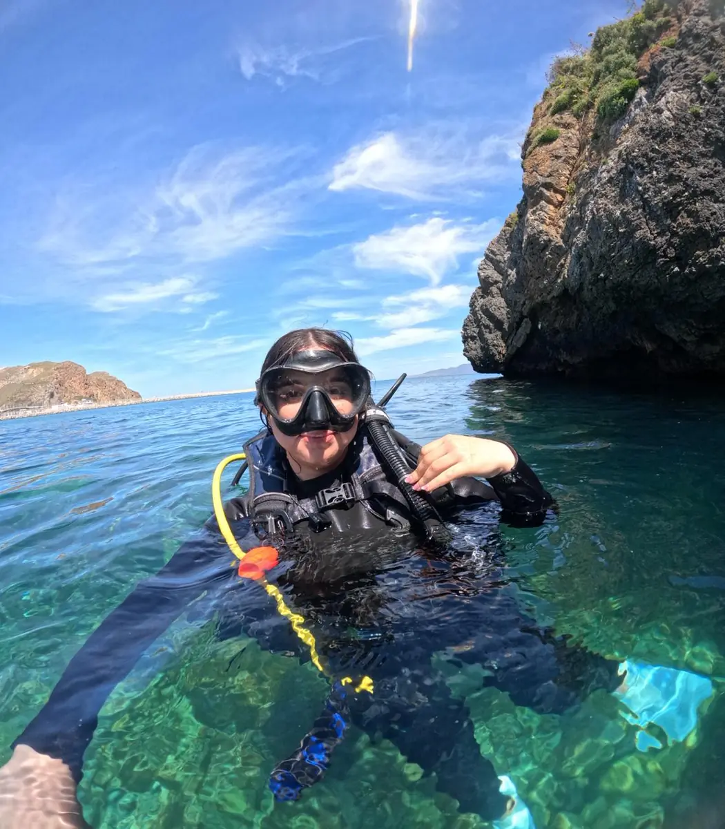 Scuba diver in clear Mediterranean water near Al Hoceima cliffs