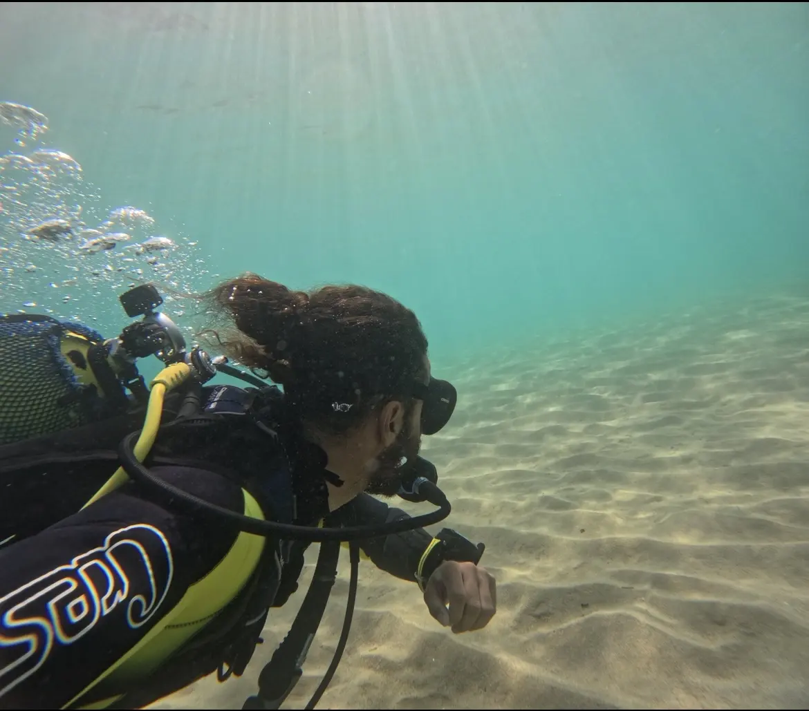 Scuba diver descending underwater in Al Hoceima