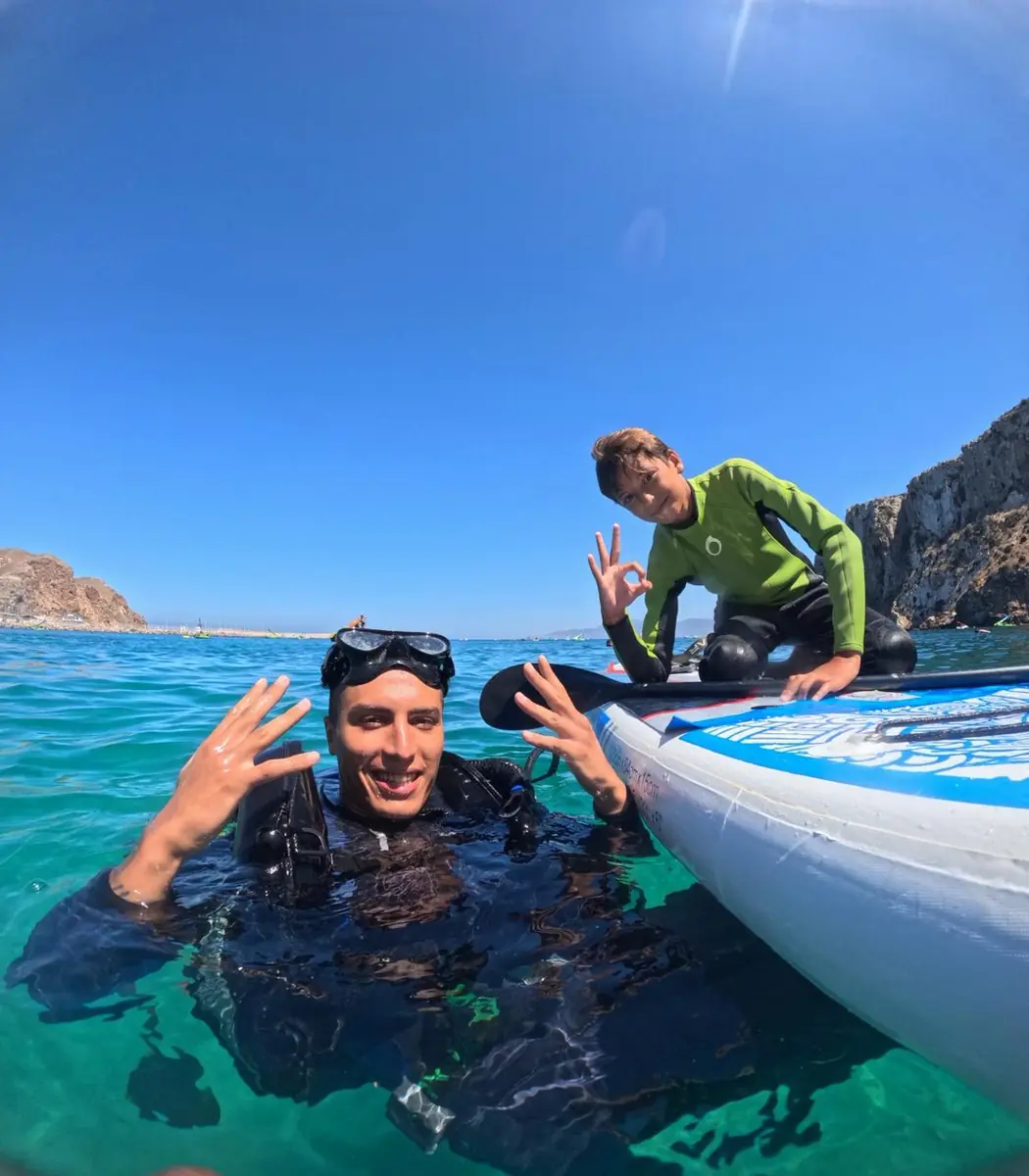 Scuba diver and paddleboarder in clear Al Hoceima water